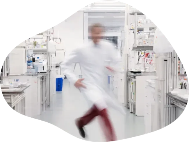 Scientist moving through a working laboratory